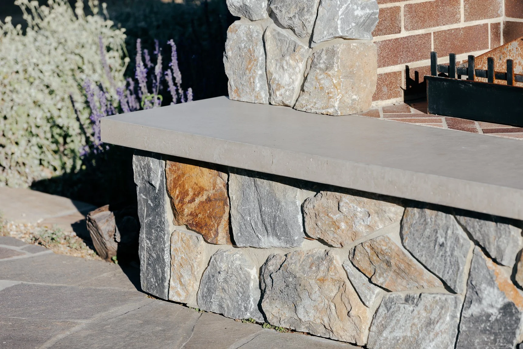 Stone outdoor bench built by Newcastle builder for custom houses.