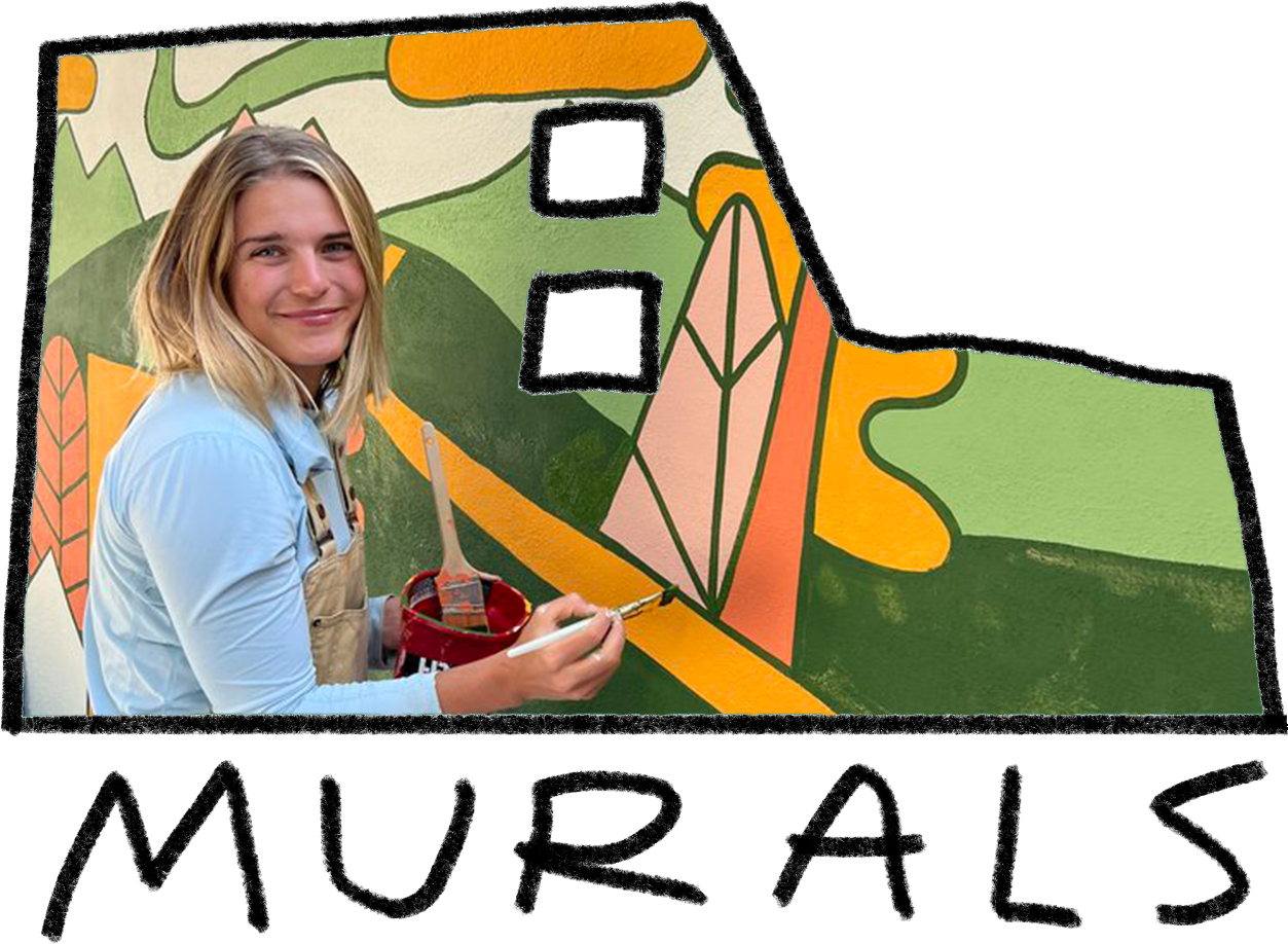 Young woman painting a colorful mural of a stylized house with abstract landscape elements on a wall.