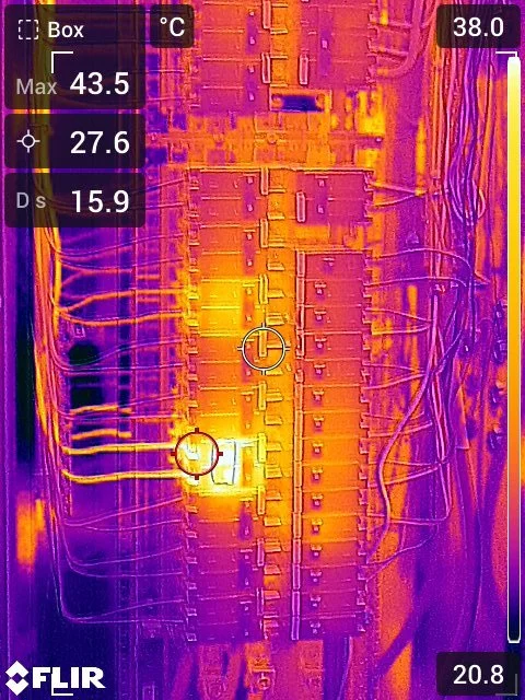 Infrared image of an electrical panel or circuit breaker box with wires connected. Temperatures range from 15.9°C to 43.5°C, with hotspots indicating active electrical components.
