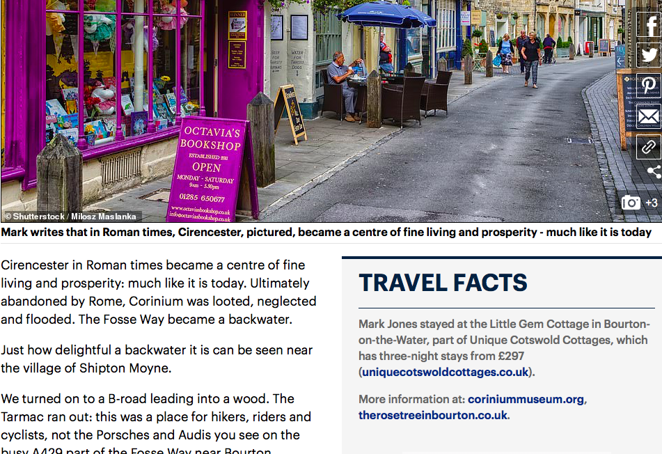 A digital article clipping featuring a street photograph of a purple bookshop in Cirencester, accompanied by travel text about Roman history and a Travel Facts sidebar section for Unique Cotswold Cottages