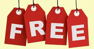 Four red hanging price tags with white letters spelling out the word Free on a light background