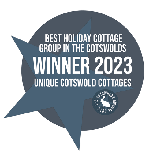 An award badge graphic reading Best Holiday Cottage Group in the Cotswolds Winner 2023 for Unique Cotswold Cottages, featuring a blue star design