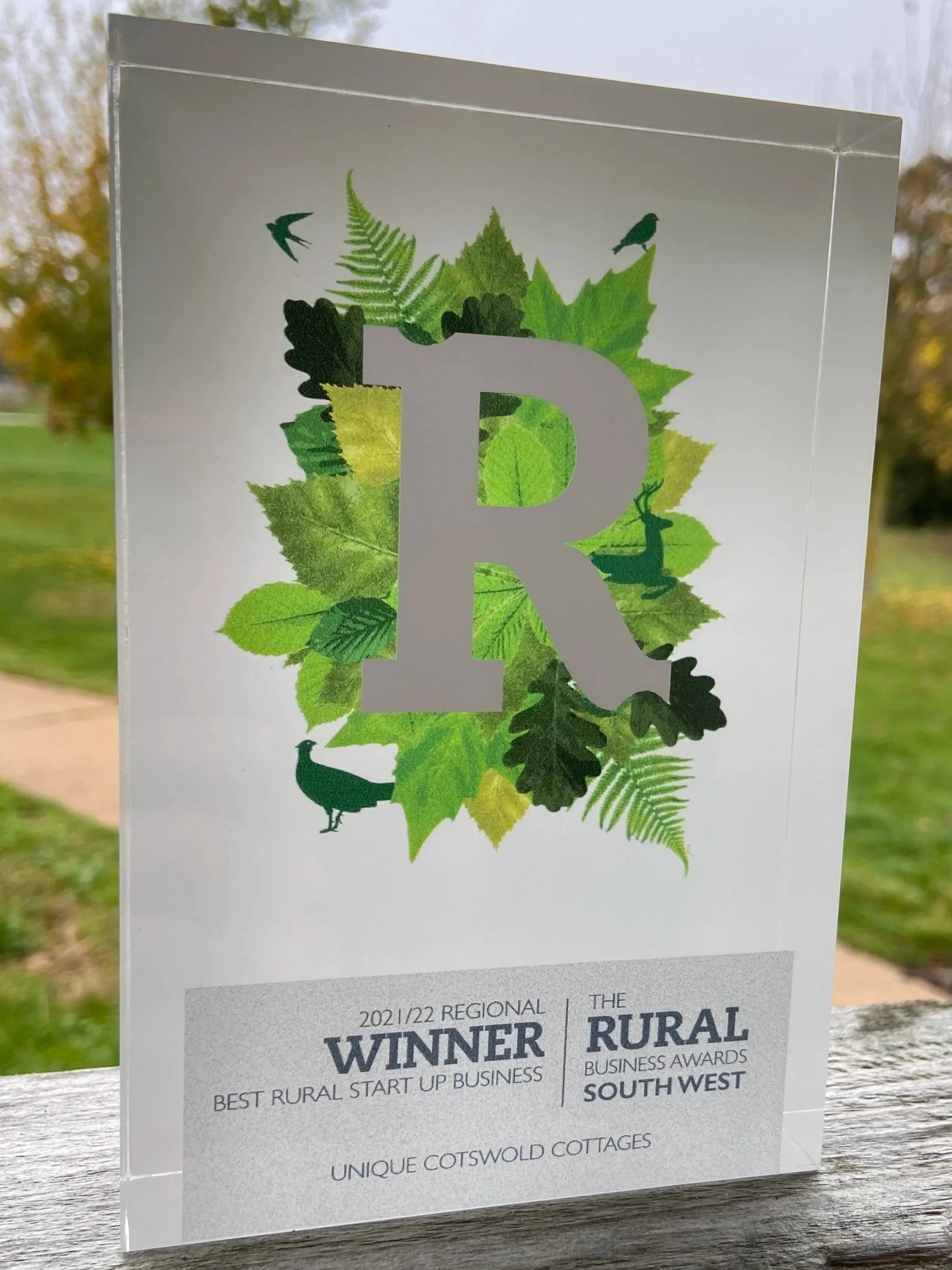 A photograph of The Rural Business Awards South West trophy for 2021/22 Regional Winner of Best Rural Start Up Business, featuring a large letter R surrounded by green leaves