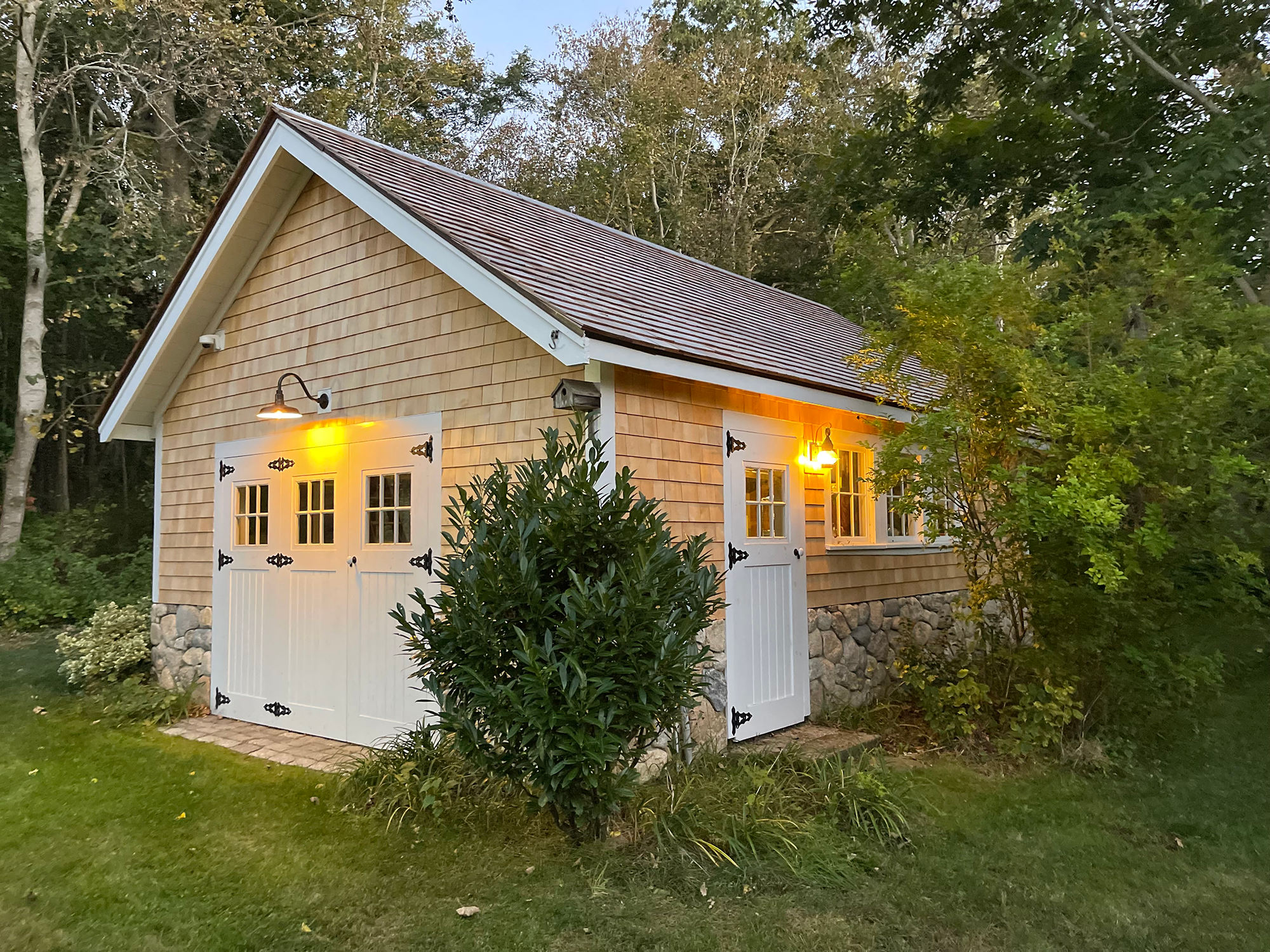 Garage remodel with new cedar shingle siding and barn doors in Orleans