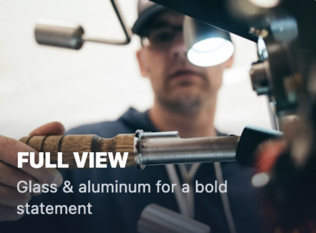 A man working with glass and aluminum, focusing on a piece of equipment in a workshop or studio setting.