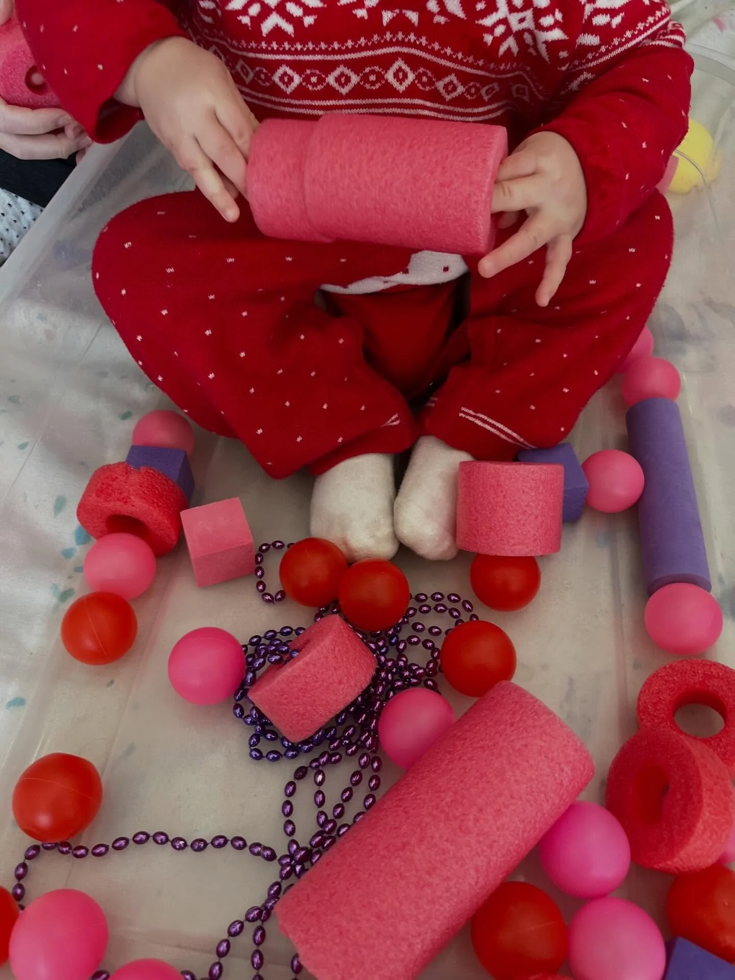 Our Messy Minis (6-18 months) took loving care of babies, squished and poked pink play dough, and practiced saying words like &ldquo;ball&rdquo; and &ldquo;baby&rdquo; while they explored loose parts in our sensory bin today. So much fun!