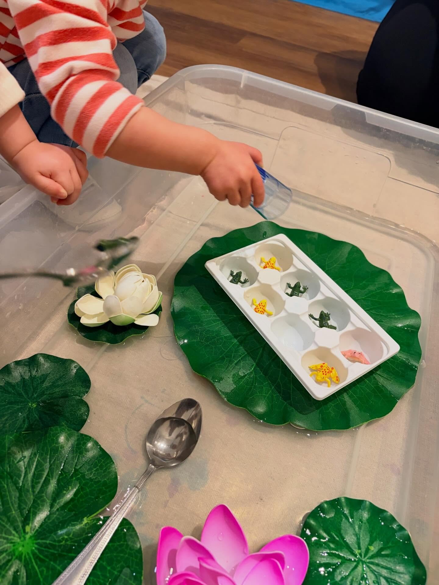 During our Claude Monet-inspired week, we explored lily pads through a variety of stations. We scooped and poured water onto lily pads, painted coffee filter lily pads with liquid watercolors, and squished blue (water) kinetic sand onto foam lily pad