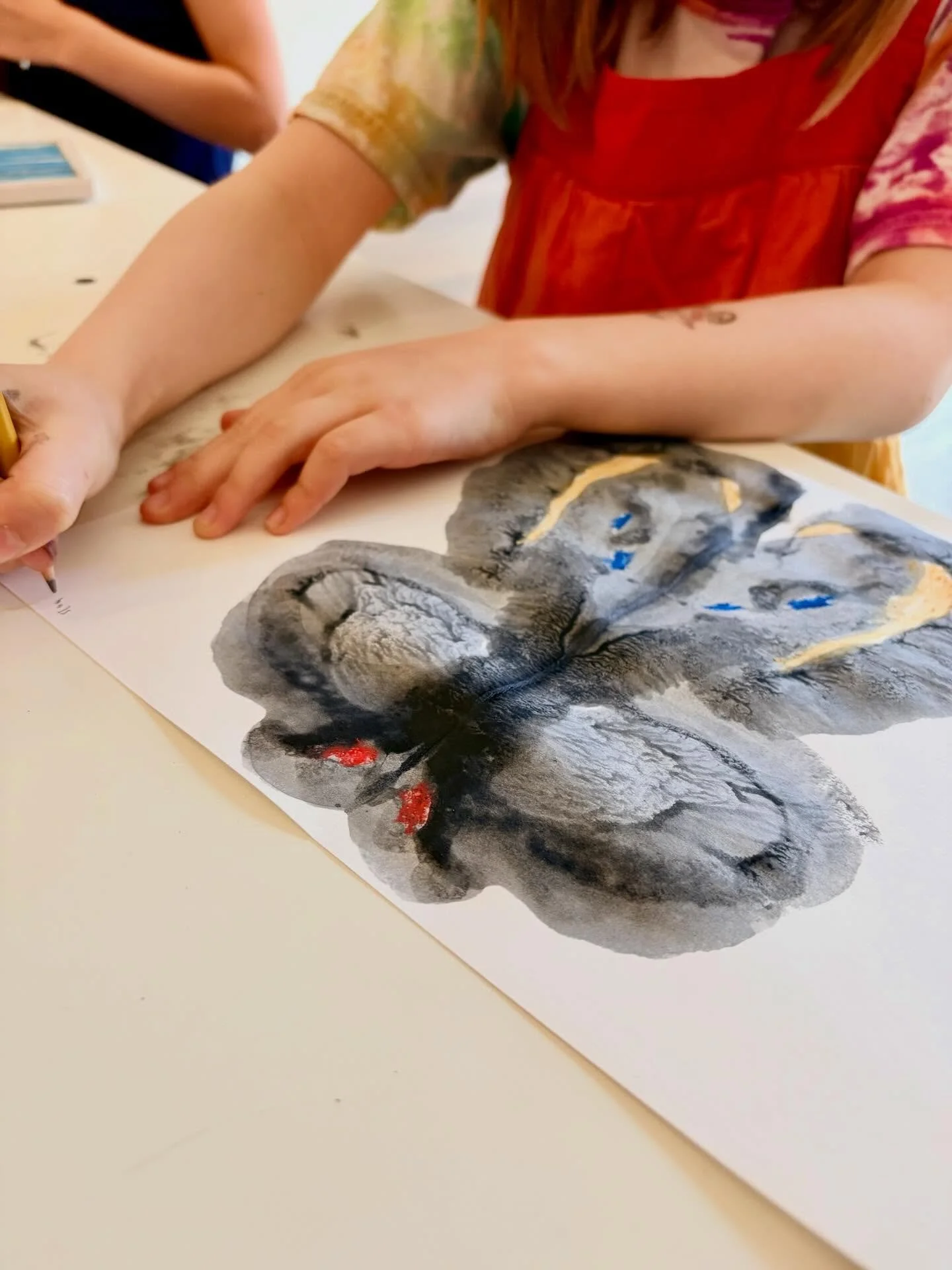 We began our new session of Wednesday Afternoon Art Explorers (K-2nd grade) yesterday. Children used watered down black paint to create symmetrical butterfly designs. We talked about what the word symmetrical means and how butterflies have symmetrica