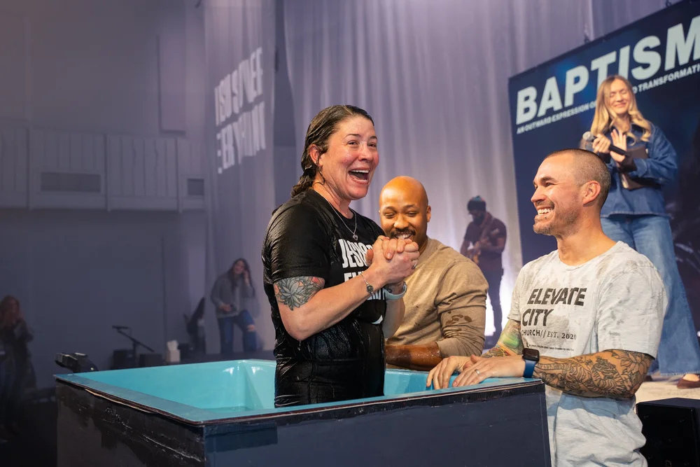 Two people celebrating together immediately after a baptism