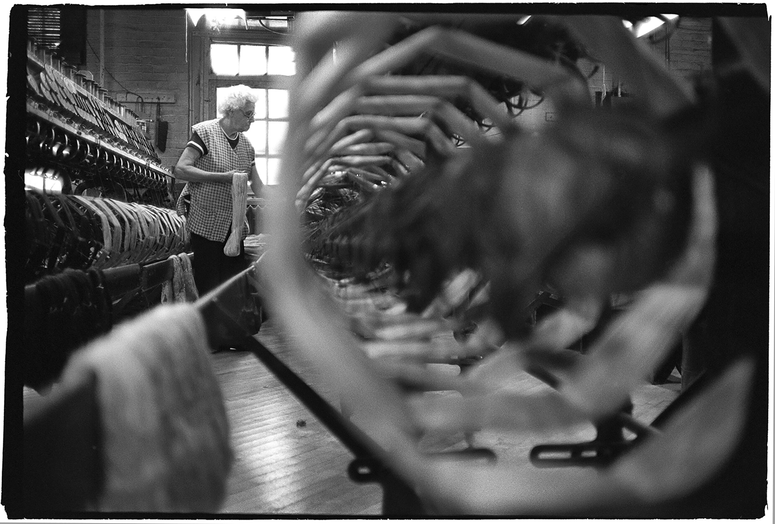 Anna Osika, a winder, monitors silk thread wining into spools.