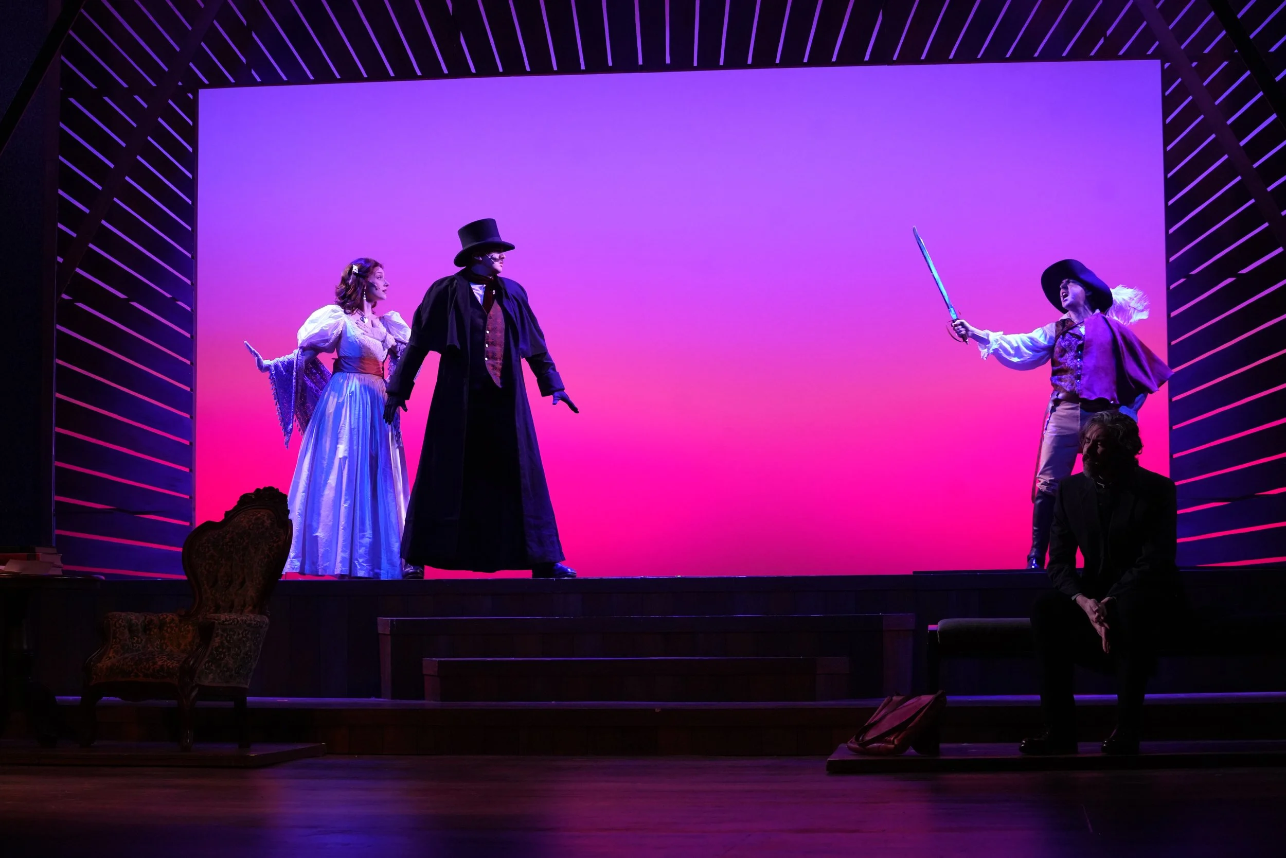 Jarrett Bloom as 'John Brooke' in "Little Women" (2026) at the Riverside Center for the Performing Arts, with Sarah Mae Andersen as 'Meg March' and Matt Beary as 'Laurie'