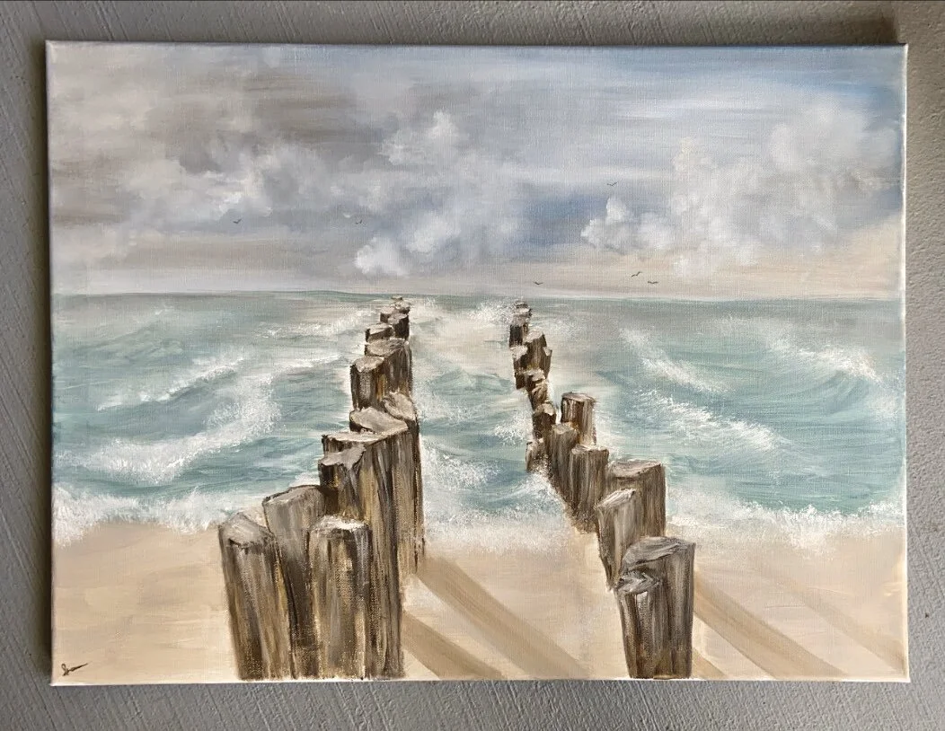 Walkway into a stormy sea at sunset.