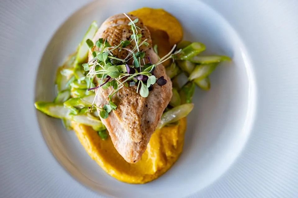 Seared chicken breast with butternut squash puree and sliced asparagus.