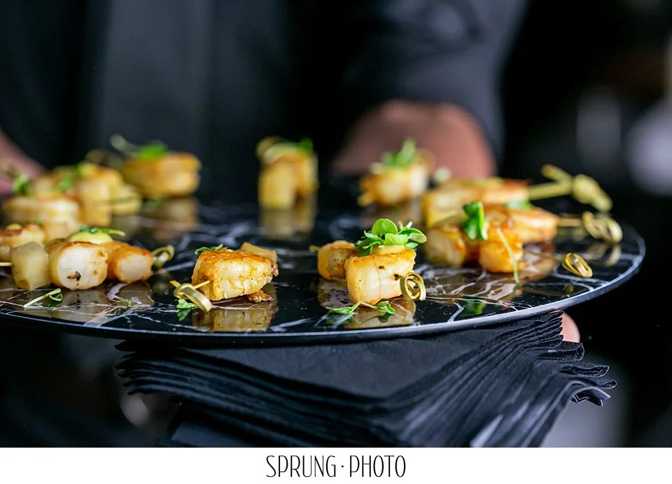 Curry marinated shrimp skewers served on a platter.