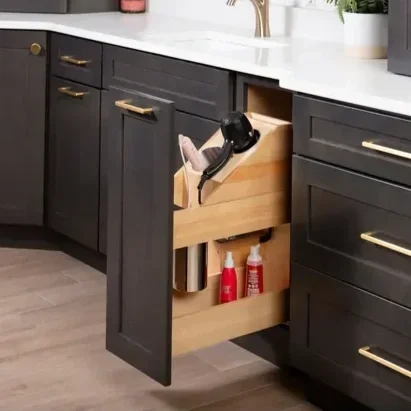 Kitchen drawer organizer with a hairdryer and bottles stored inside.