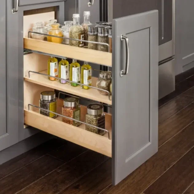 Kitchen cabinet with pull-out spice rack containing various spices and jars.