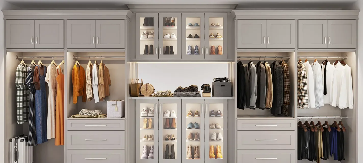 A closet with gray cabinetry and organized clothing, shoes, and accessories on shelves and hanging rods.