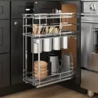 Stainless steel kitchen cart with three shelves containing food items, placed in front of dark kitchen cabinets.