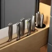Set of five knives on a wooden knife holder
