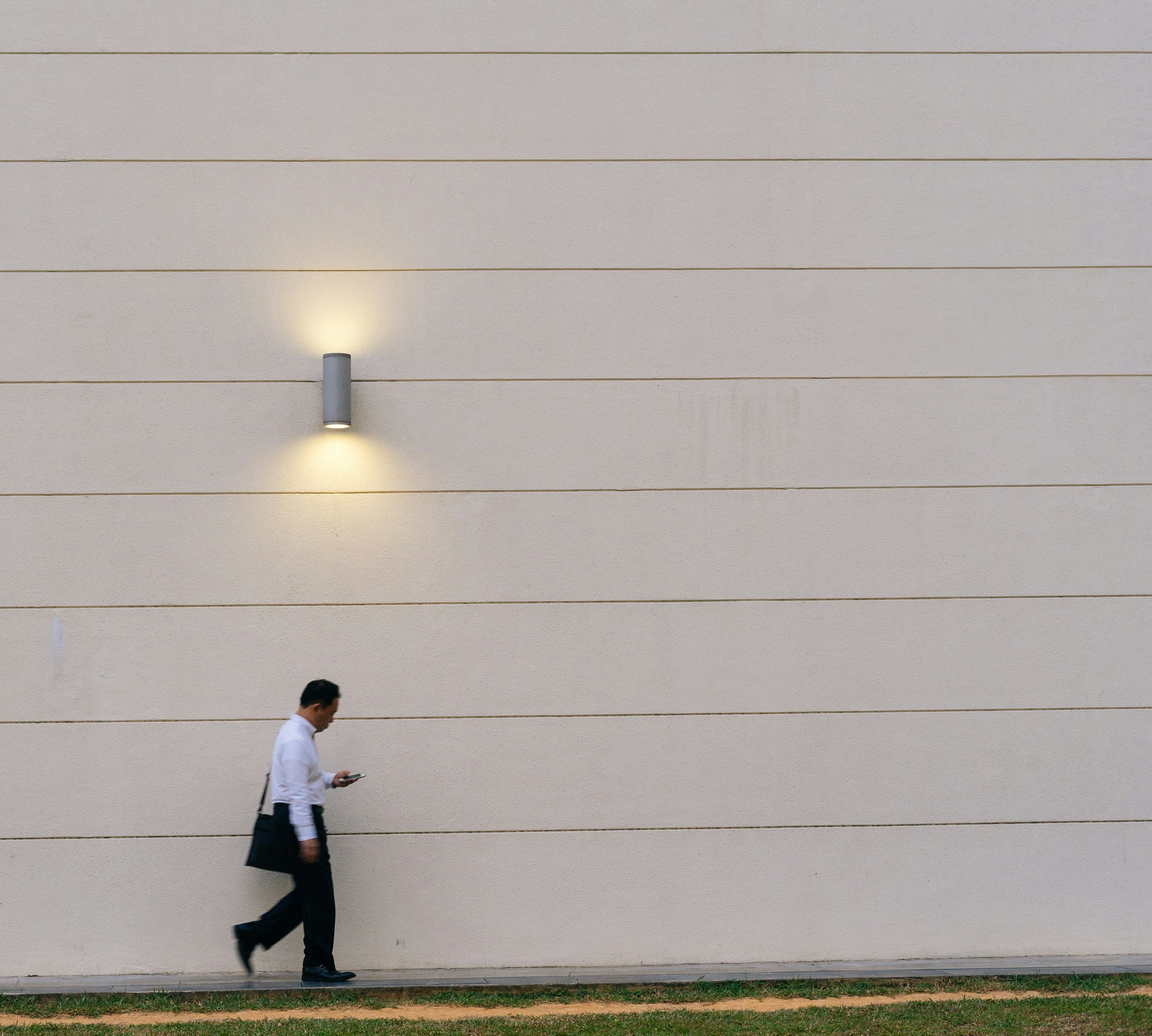 A cinematic shot of a professional looking out over the Singapore CBD skyline at sunrise, representing long-term vision
