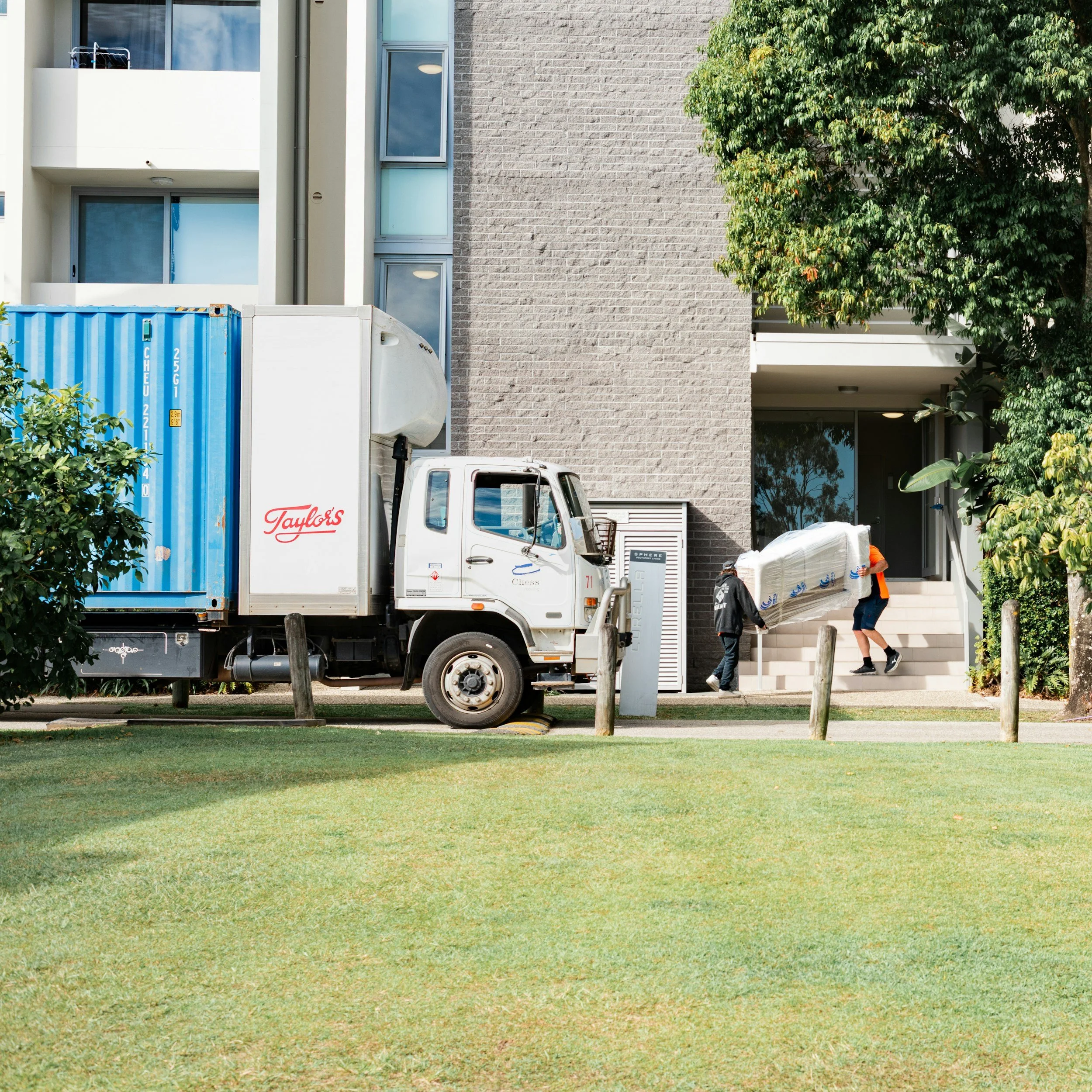 An executive property relocation showing a professional full-service moving team safely packing high-value art and assets inside a premium Singapore residence.