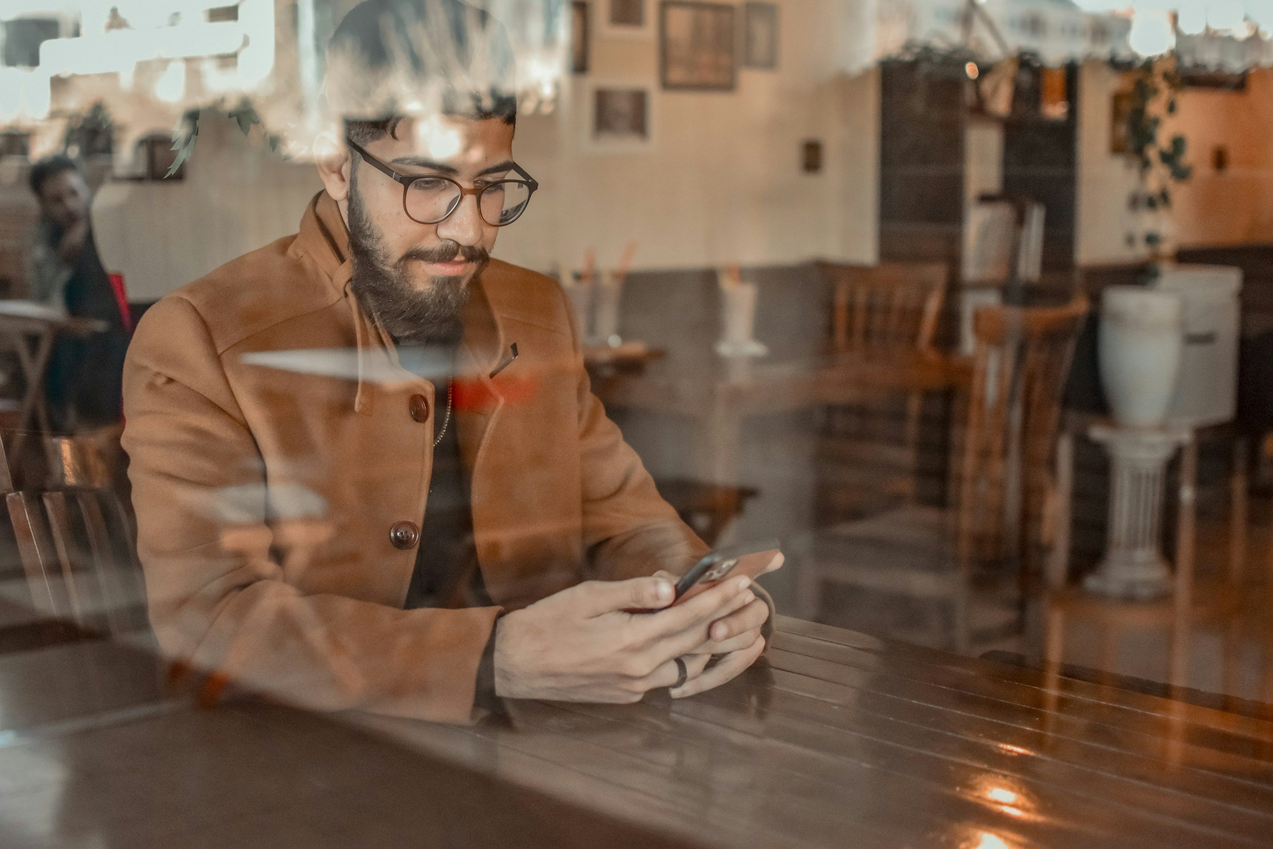 A professional in Singapore comfortably reviewing automated savings progress on a mobile banking app.
