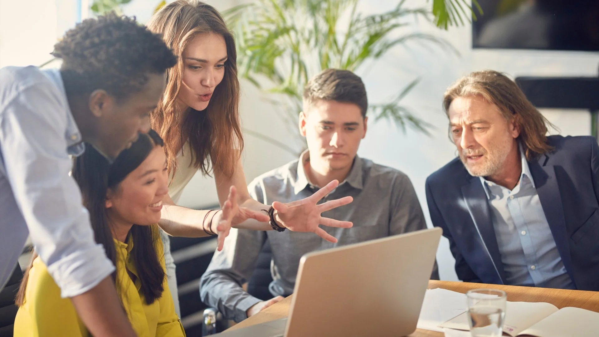 Diverse team of professionals in Singapore collaborating, illustrating crucial communication and problem-solving skills.