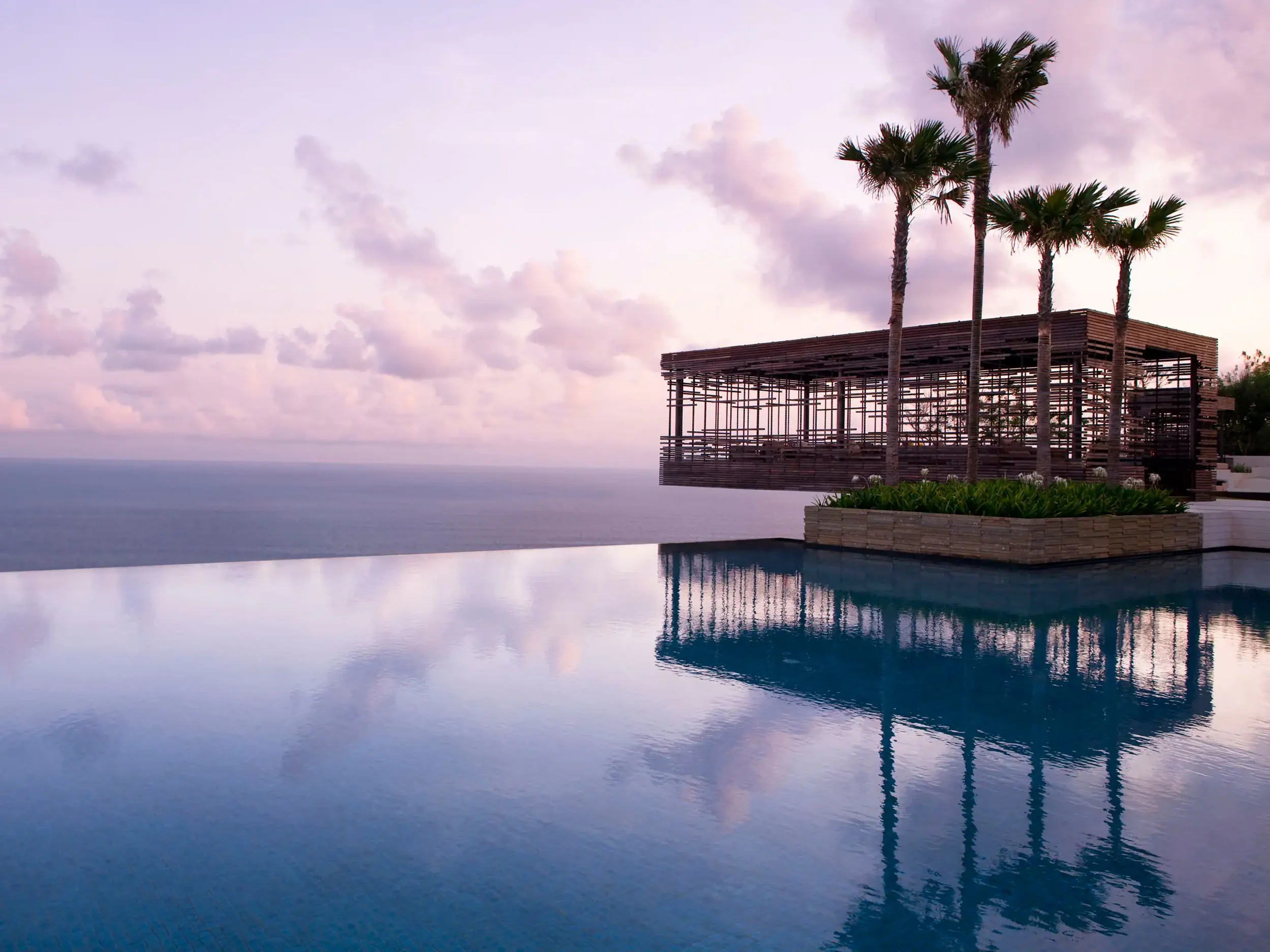 The iconic overhanging cabana at a luxury Uluwatu resort at sunset