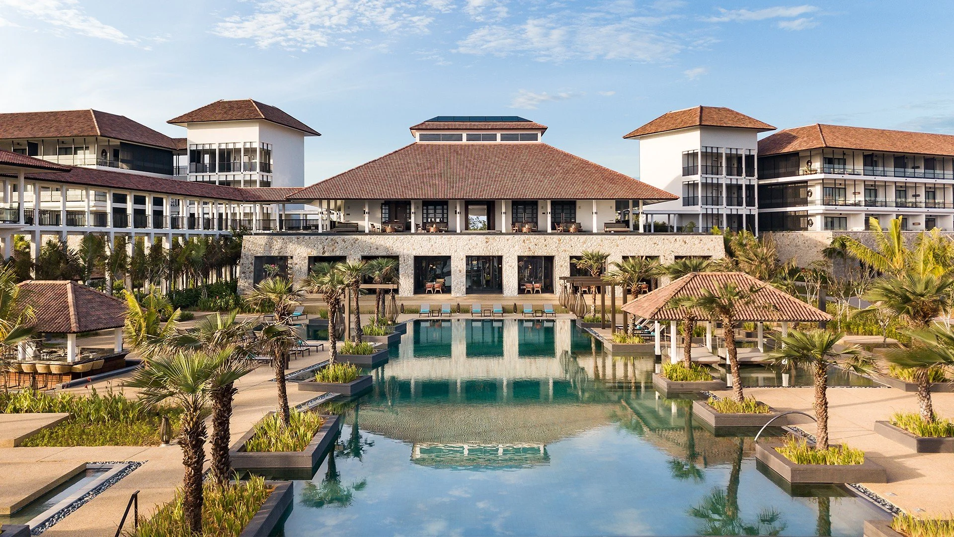 An infinity pool at a luxury Desaru resort overlooking the South China Sea at sunrise