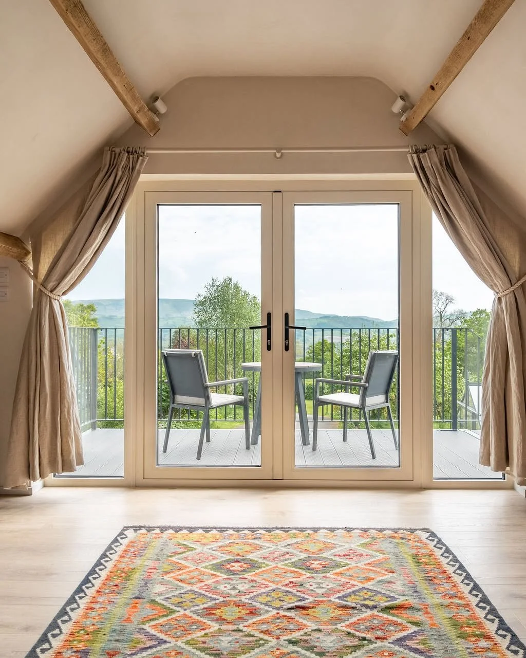 Designing within characterful spaces often means problem-solving in ways that aren&rsquo;t immediately obvious. In this conversion, the angled ceiling and exposed beams meant that a standard curtain rail just wouldn&rsquo;t work. Instead, Kate design