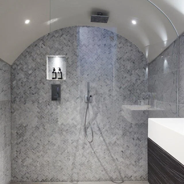 This bijoux basement bathroom was an interesting challenge with its low, curved ceiling.  The tiler not as keen on the Carrara marble mosaics as I was but did a great job installing them #carraramarble #marblemosaic #basementbathroom #marblebathroom 