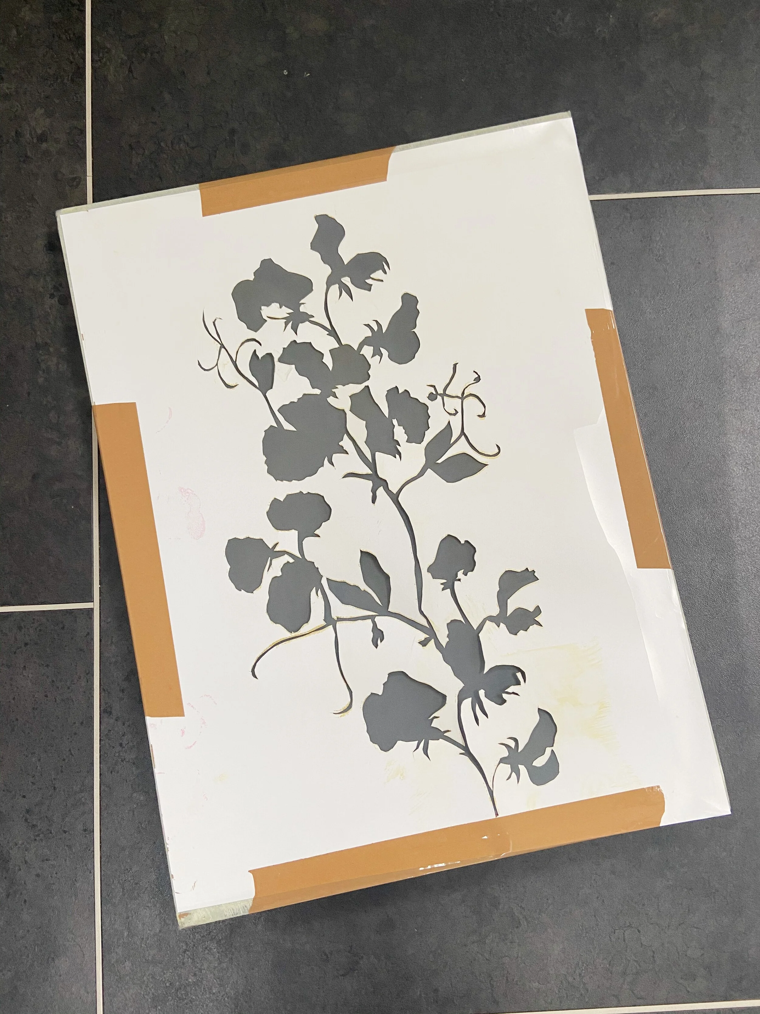 Cut stencil taped to screen