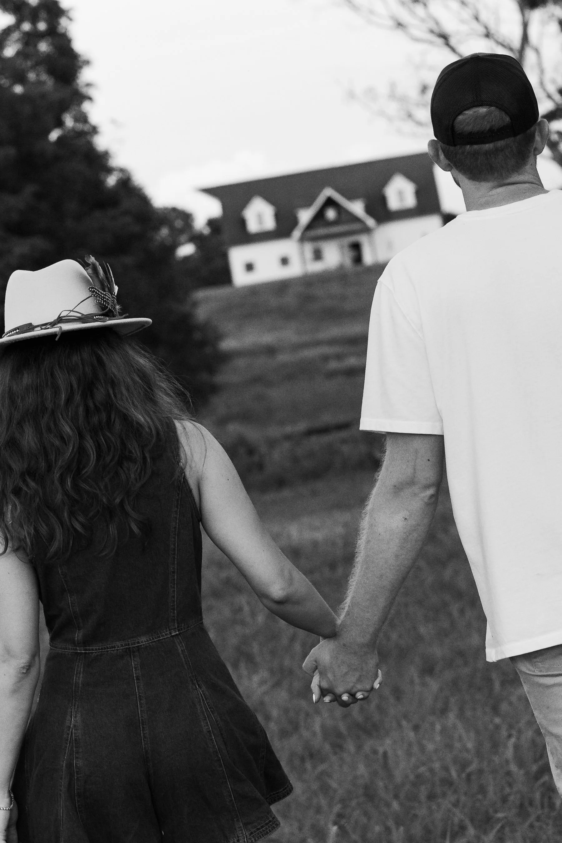 Couple walking toward farmhouse