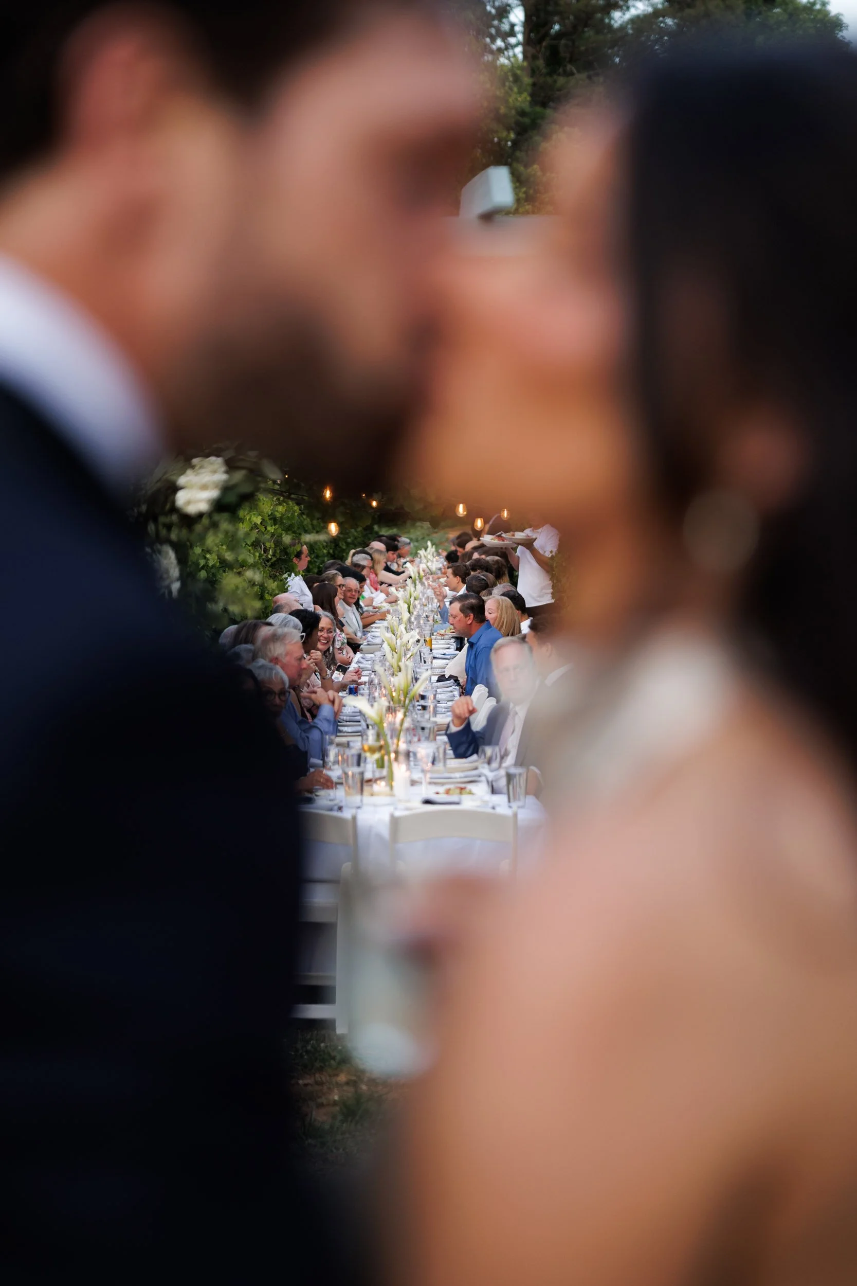 Bride &amp; Groom Kiss Revealing Reception Table Setup