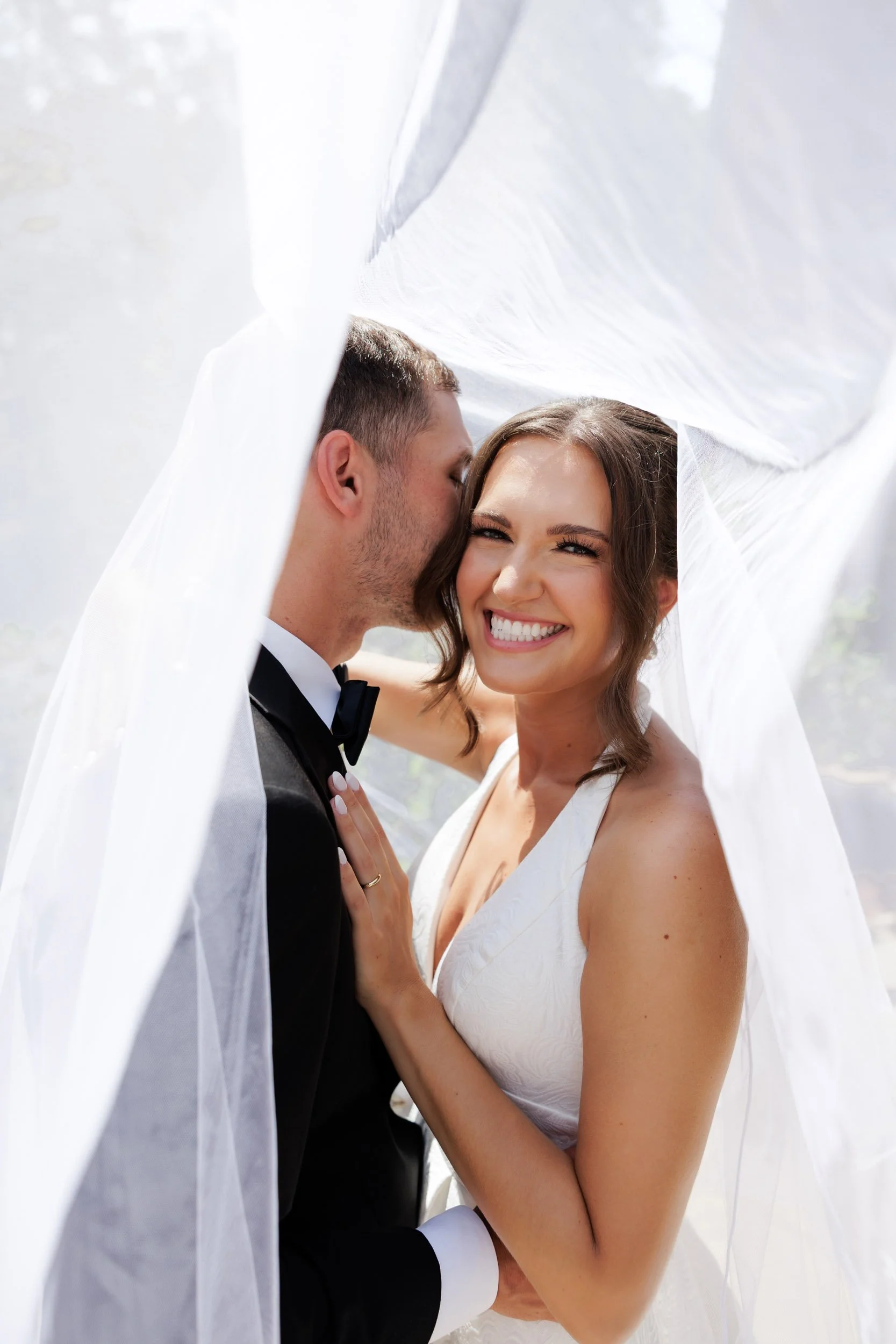 Bride and groom intimate moment under veil at Juliette Chapel in Dahlonega