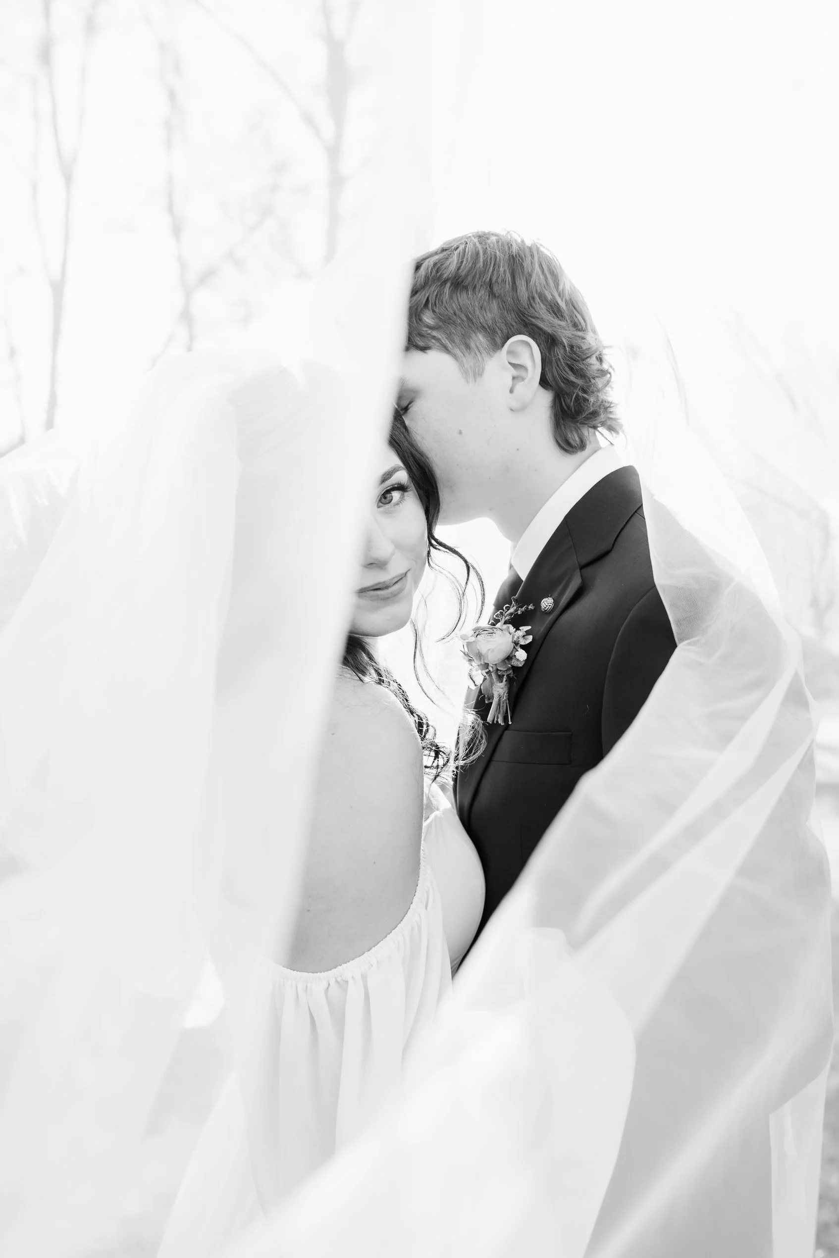 Bride and groom intimate moment under veil at wedding photographed by Southeast wedding photographer Daniela Conroy