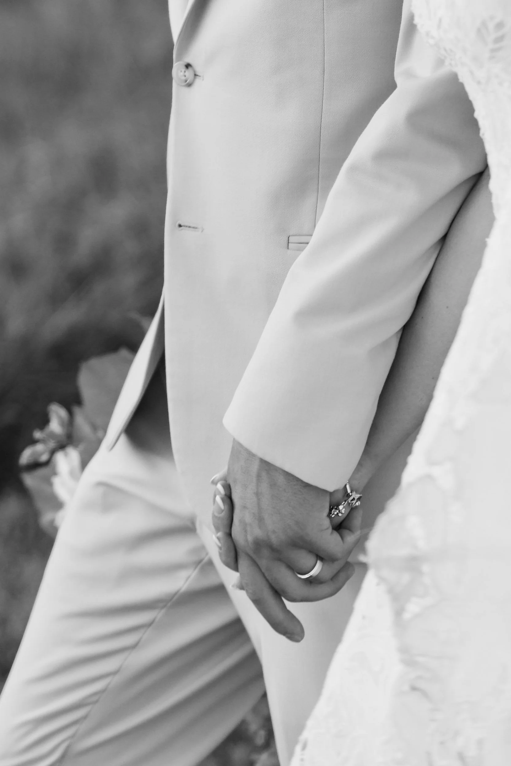 black and white editorial detail of bride and groom holding hands at grant hill farms in commerce, georgia