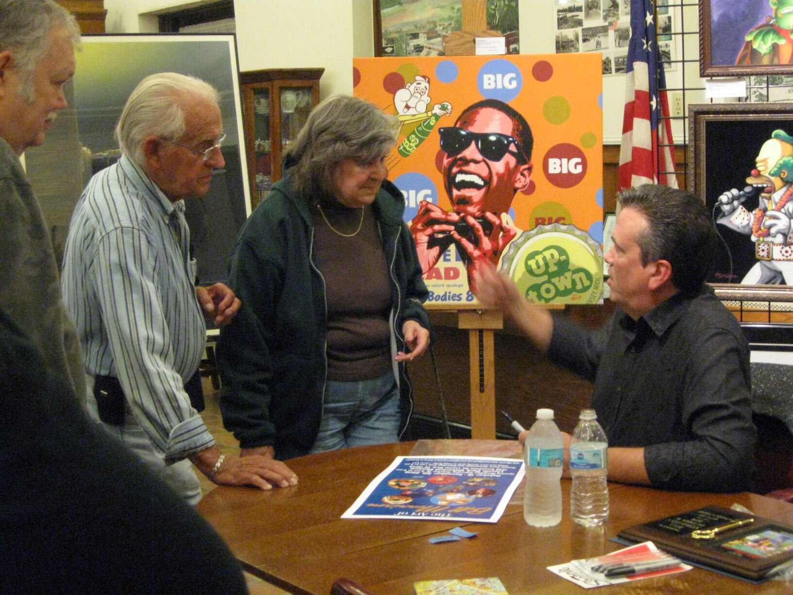 Bill Morrison, seated at right, greets guests at the opening reception for “The Art of Bill Morrison”