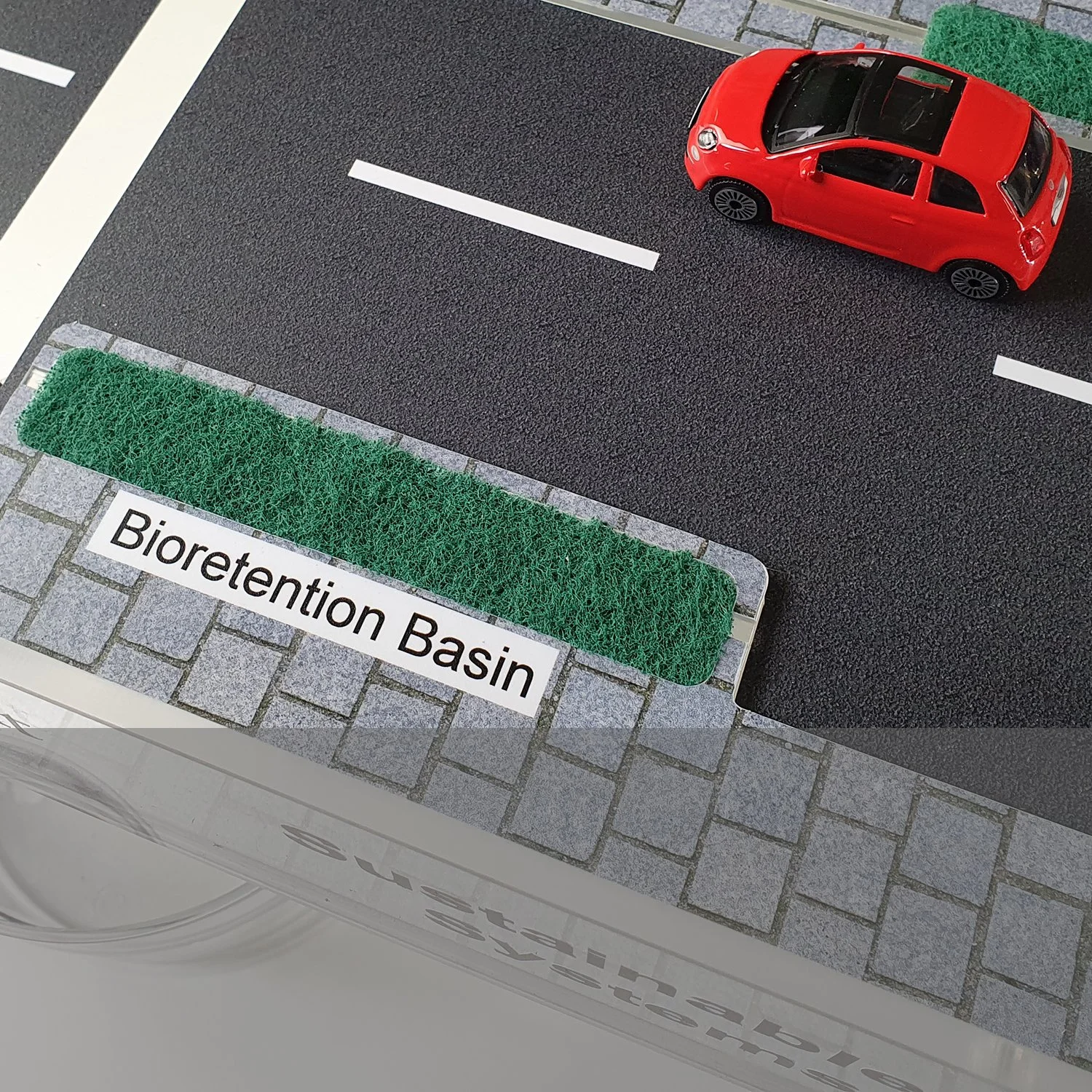 Additional excess rainwater from the road is also absorbed by a bioretention basin , which filters down into an underdrain system.