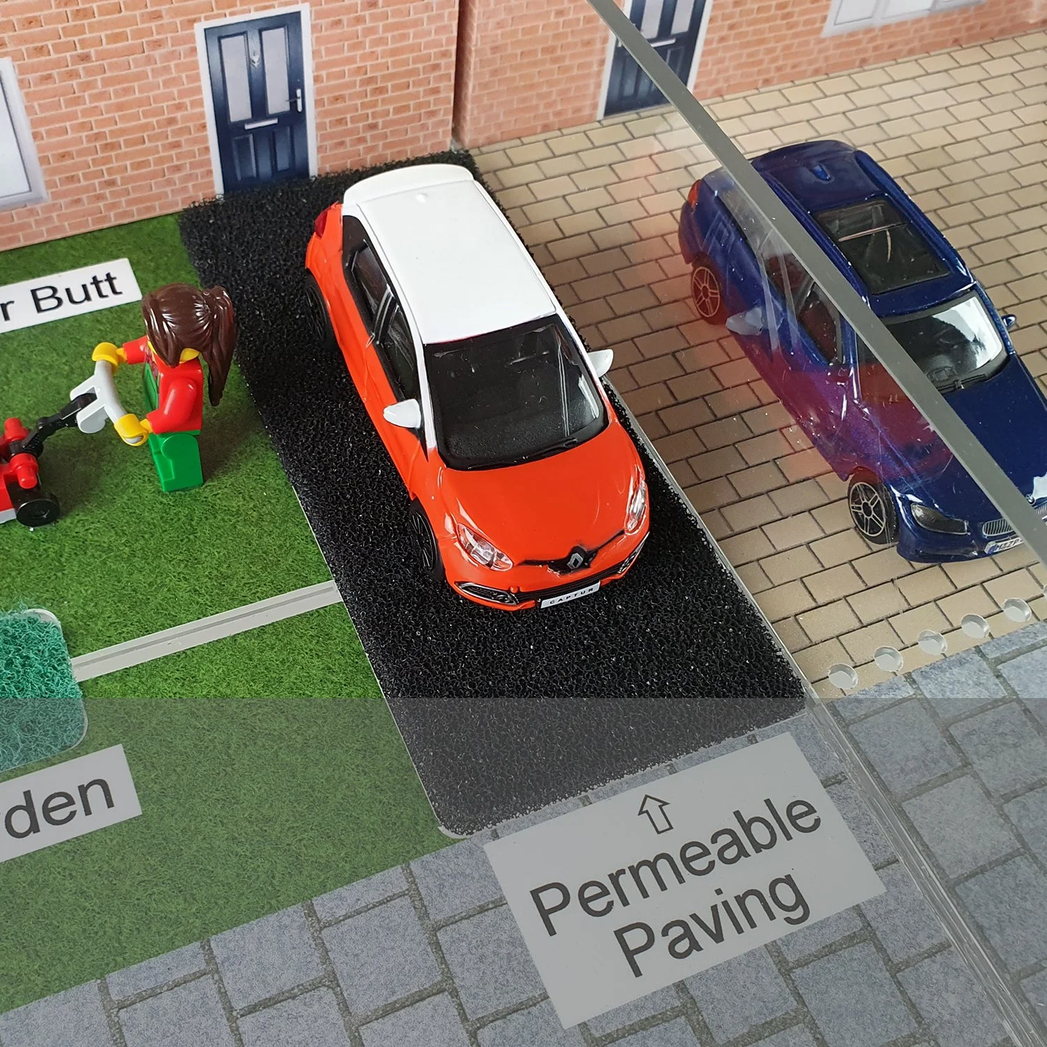 The permeable paving of the driveway allows some rainfall to infiltrate into the ground, and some is channelled to the rain garden.