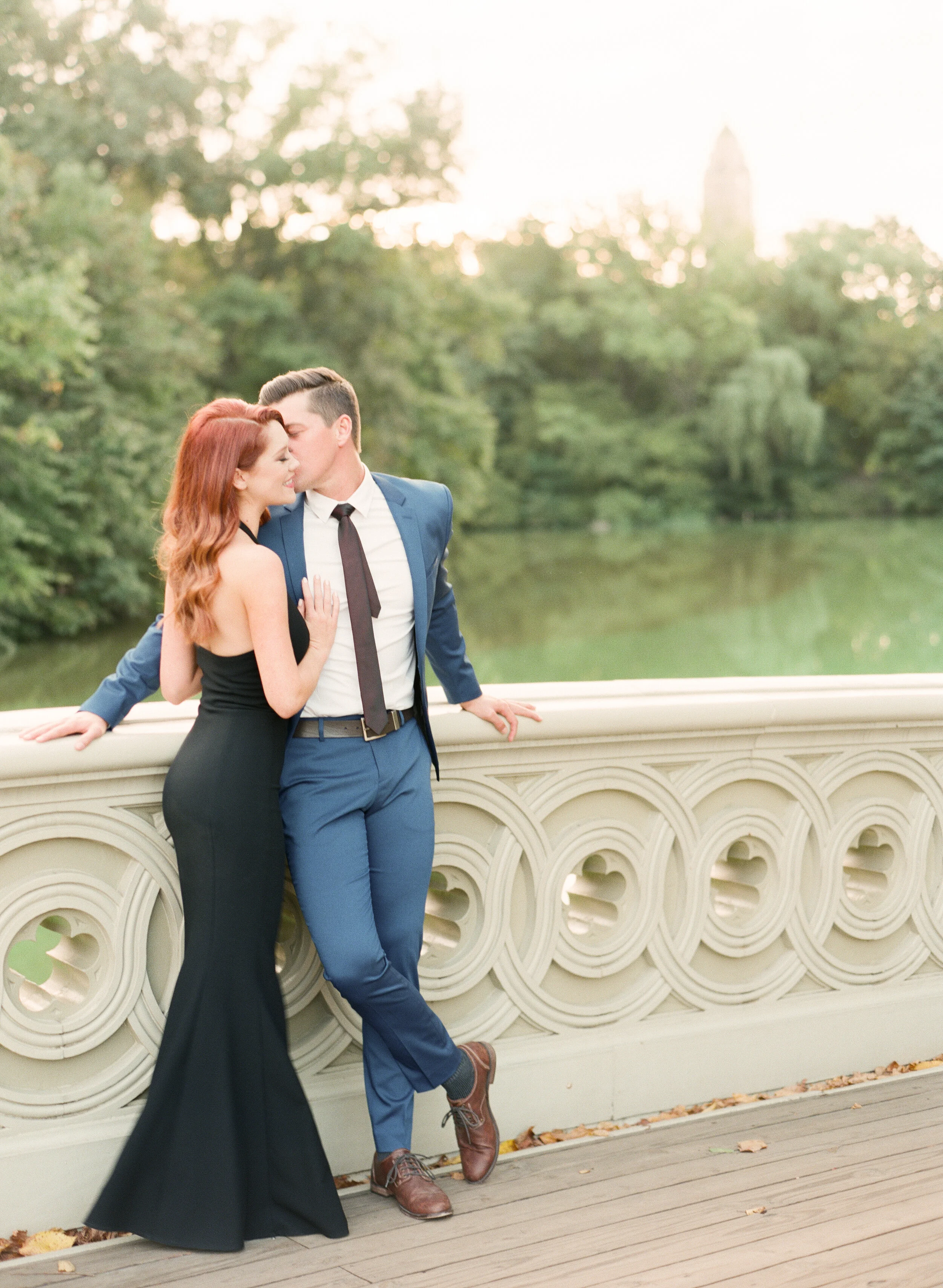 Central Park wedding photographer classic black dress engagement session on Bow Bridge