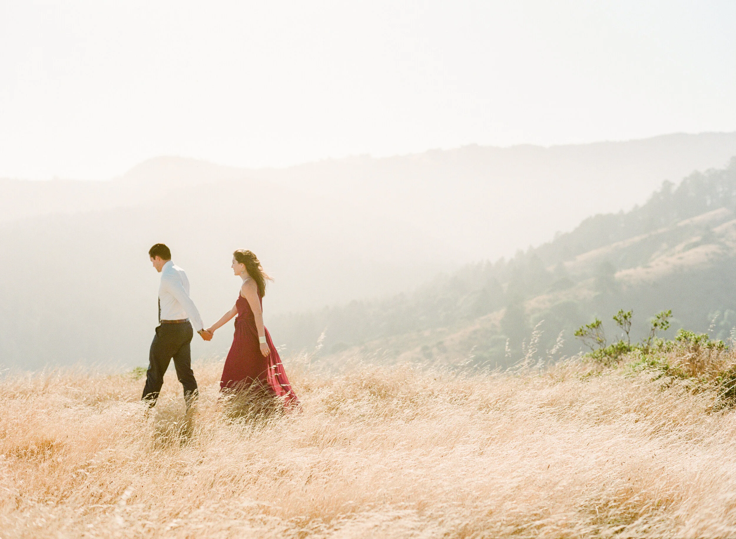 San Francisco wedding photographer couple holding hands over the California hillside mountaintop engagement - Oklahoma City Wedding Photographer