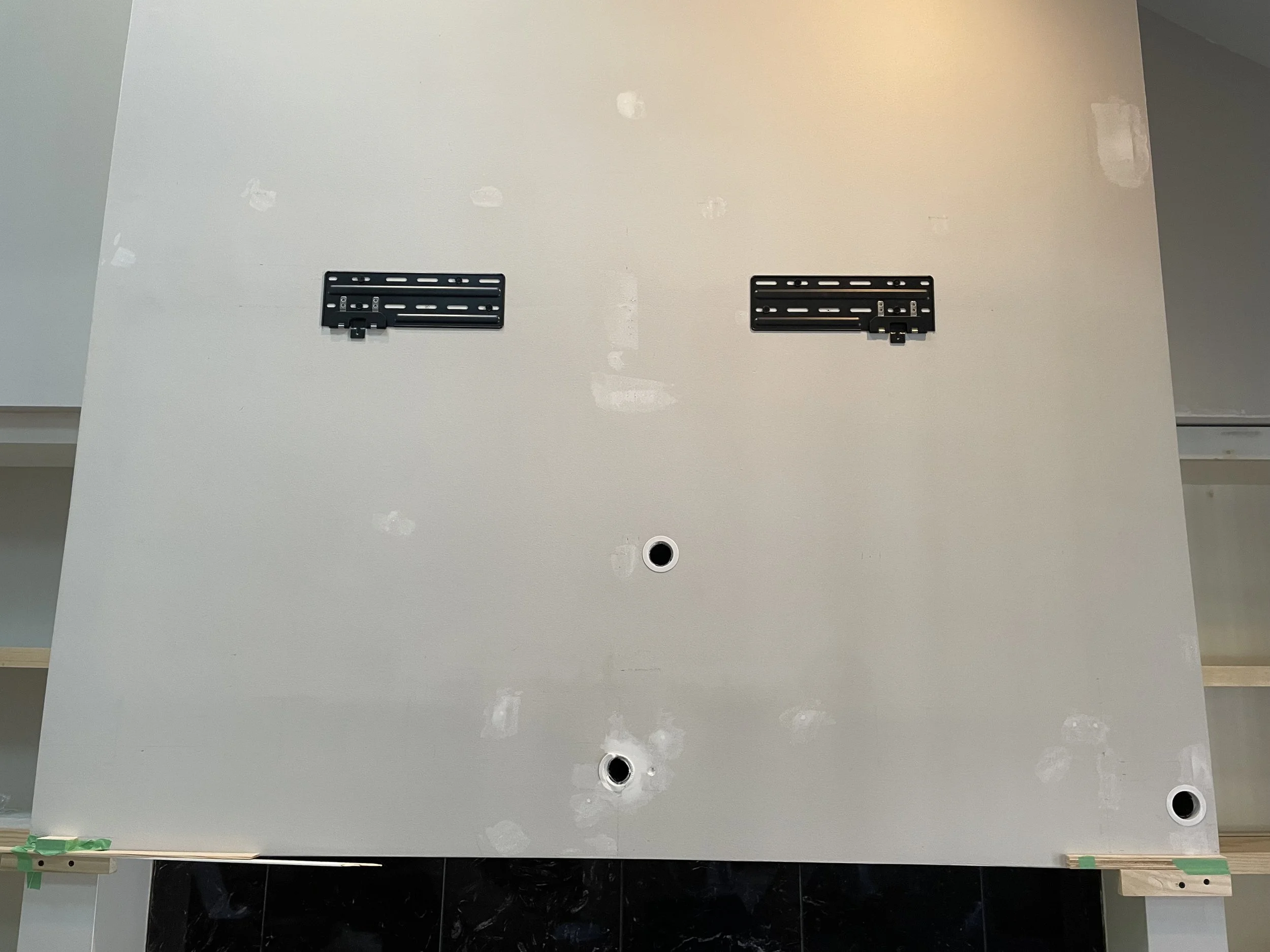 Creating a path for TV wires to be fed through the mantle and wall into the cabinet