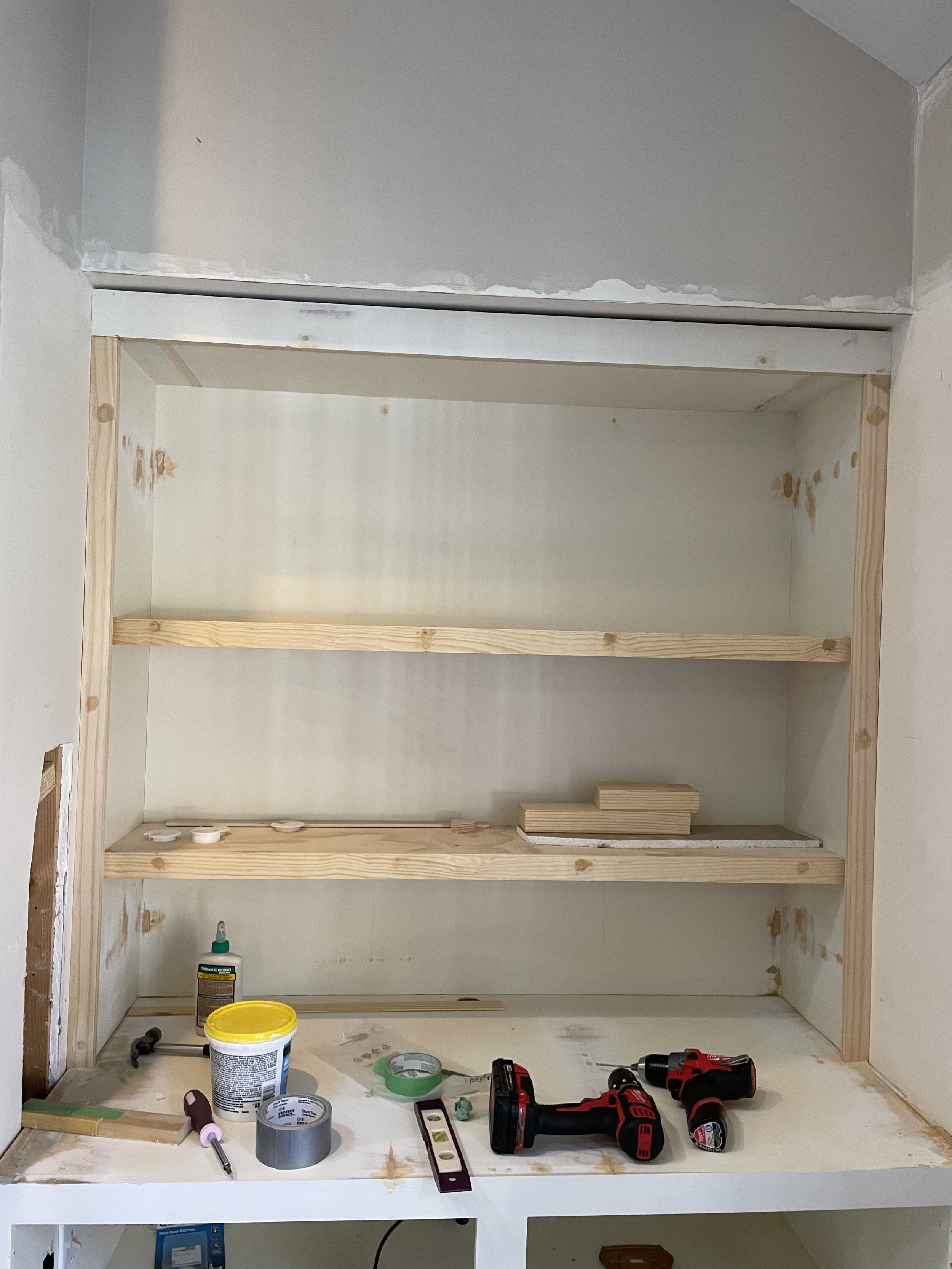 Installing shelving in the right cabinet to match the shelving on the right cabinet