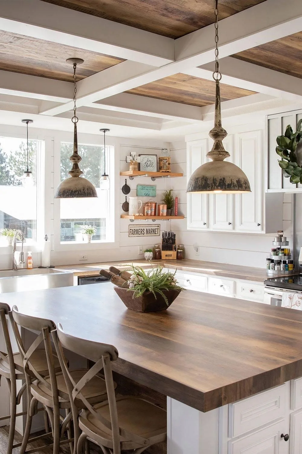 A warm kitchen island with a butcher block or live-edge walnut top, surrounded by stone perimeter counters