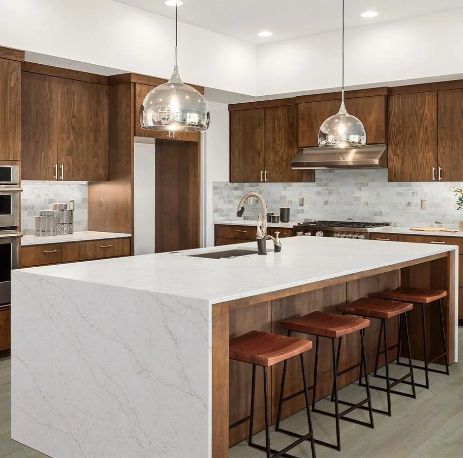 A clean, modern, or transitional kitchen with white or soft-toned quartz countertops — minimal, bright, serene