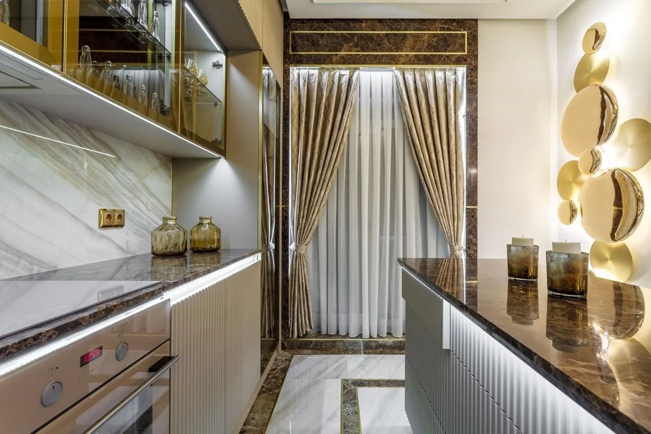 A rich, warm traditional kitchen with bold granite countertops — dramatic veining, warm tones