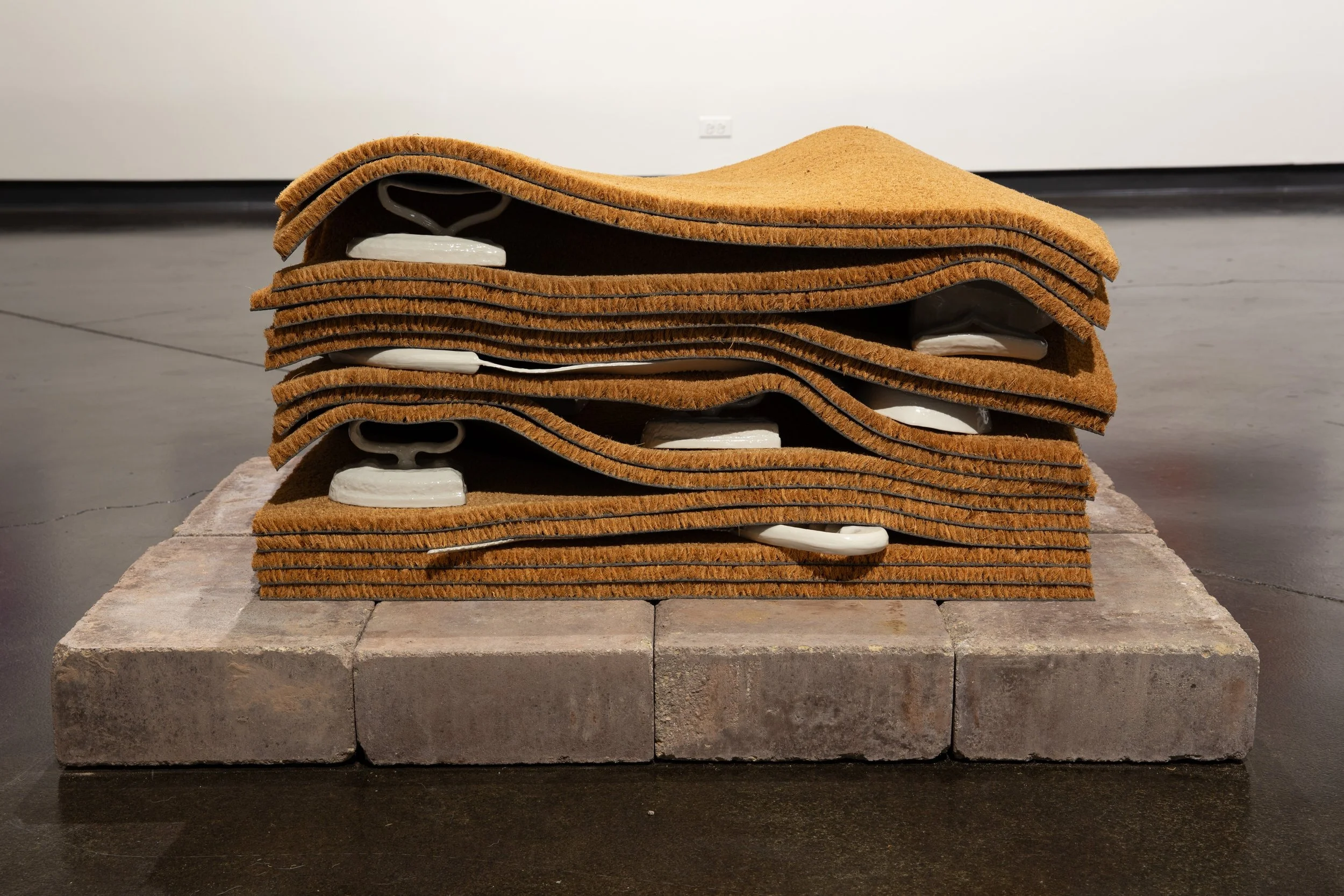 LaRissa Rogers,  a stratigraphic threshold of broken inheritance , 2025, porcelain slip-cast family heirlooms, rugs