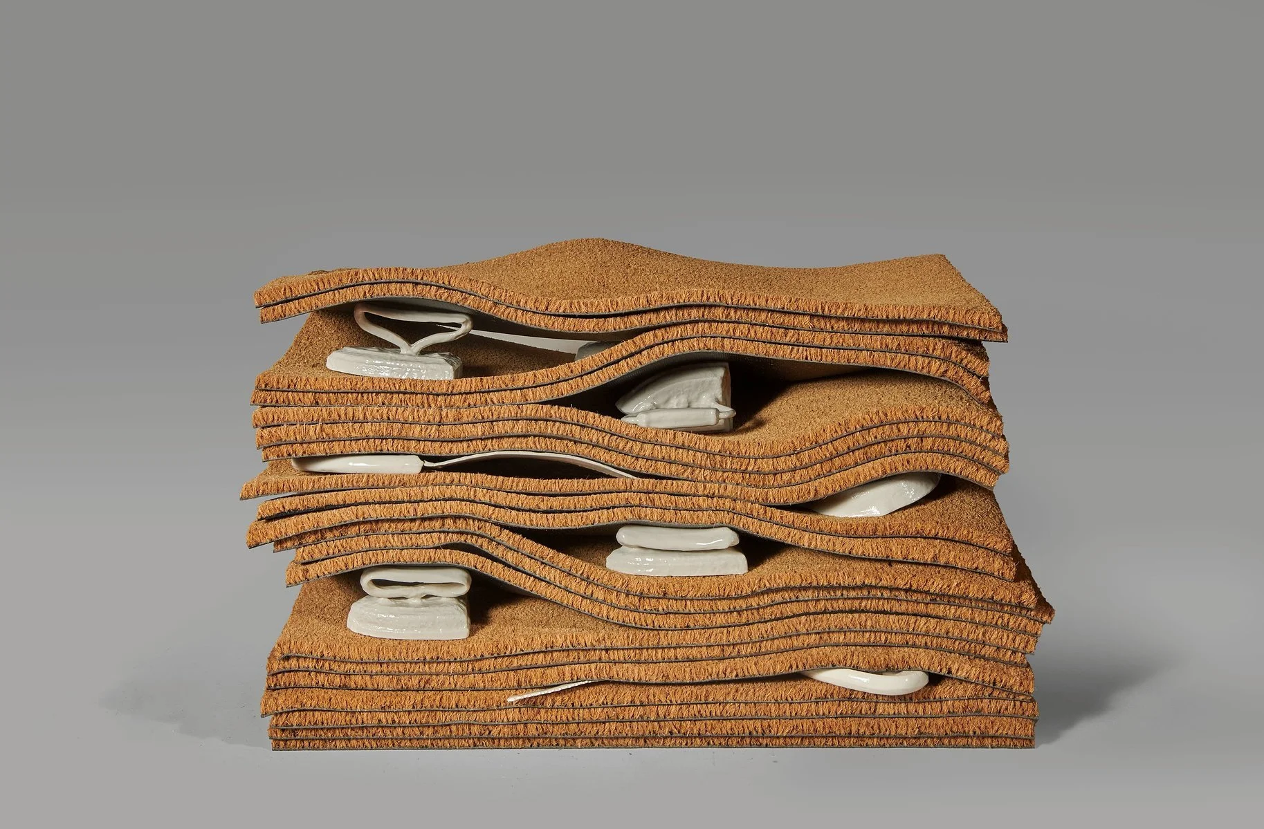 LaRissa Rogers,  a stratigraphic threshold of broken inheritance (I) , 2025, door mats and slip-cast porcelain family heirlooms, photo by Thomas Clark, image courtesy of MCLA 51 Gallery 