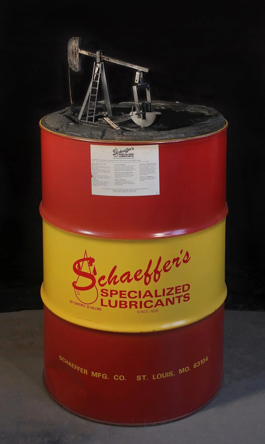  Schaeffer’s Gift to the World , 2017, surplus oil drum, metal, asphalt, oil paint, pump, motor, plastic tubing, mineral oil